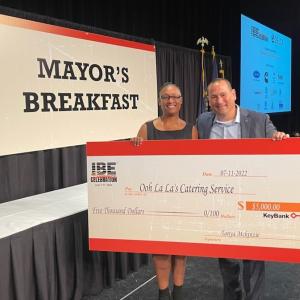 Lakeshia Peterson shown with check from KeyBank for Black Business Training.