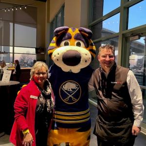 KeyBank volunteers shown with mascot.