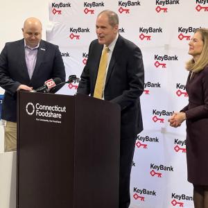 KeyBank's Matthew Hummel speaking to the group from a podium.