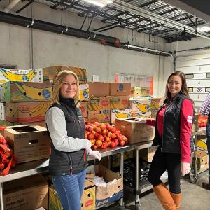 Volunteers at Conn. Food Share warehouse preparing food packages.