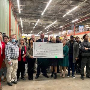 KeyBank and RecycleForce employees shown holding the $300,000 grant.