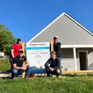 KeyBank volunteers in front of completed home on KeyBank build day.