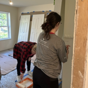 KeyBank volunteers painting walls. 