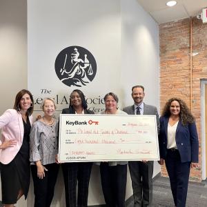Representatives from The Legal Aid Society of Cleveland accept an $800,000 grant check from KeyBank.