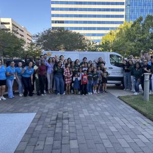 Group picture in front of the delivery van that Baker Hughes has donated to Kids' Meals