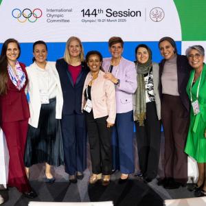 Group photo of Kirsty Coventry surrounded by other women