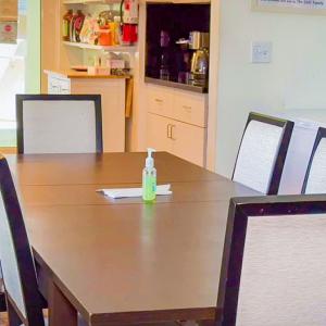 Clean dining table and kitchen.