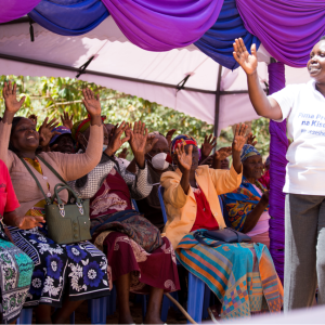 speaker and an audience clapping