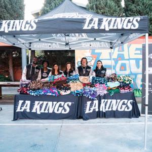 LA Kings staff distributing blankets under a tent