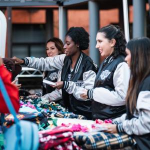 LA Kings staff distributing blankets under a tent