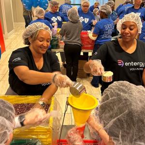 Volunteers scooping and packing food.