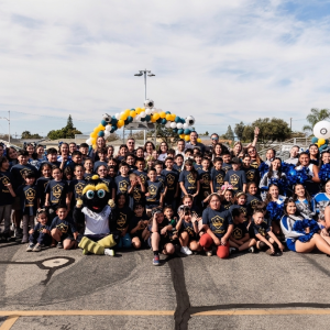 Large group photo of students, staff, and LA Galaxy representatives on the new court.