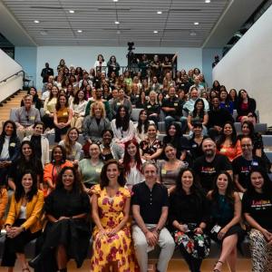 Large group of people posed on bleachers