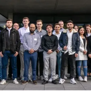 Group of people stood together near lenovo banner