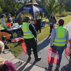 People wearing hi-vis vets near an event stand
