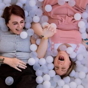 Lanie and Renee shown in a box of bubbles.
