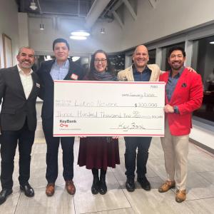 A group of people holding a cheque 