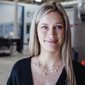 Laurel Meeks, smiling, machines behind her.