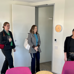 Four people stood in a room smiling