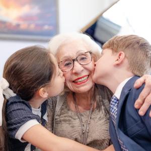Abuela smiling with two children