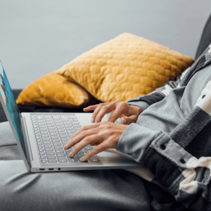 person in a home setting typing on a laptop