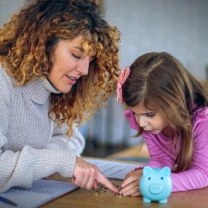 Woman and little girl discussing a lesson about money