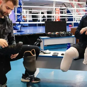 Co-founder of Danish NGO Levitate, Lasse Madsen, fits a shoe to a new "everyday foot" built for Ukrainian soldier Volodymyr, who lost his right foot in combat in Summer 2023. Volodymyr was the first recipient of a sports prosthetic from Levitate when it expanded its operations to Ukraine later that year. Direct Relief has supported rehabilitation services since the beginning of the war. (Nick Allen/Direct Relief)