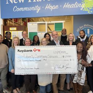 Check presentation of $120,000 to Liberty Community Services.