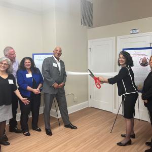  Lifting Up Westchester staff and supporters join Chief Executive Officer Anahaita Kotval (center right) and KeyBank Market President John Manginelli (center left) in cutting the ribbon on the new LUW Job Central. 