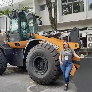 A person stood in front of agricultural machinery 