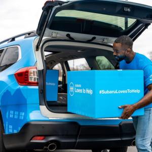 Loading a box into the back of a Subaru 