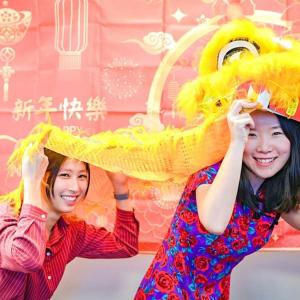 Two people holding a lion dance costume