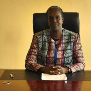 Lydia Nsekera sitting at a desk
