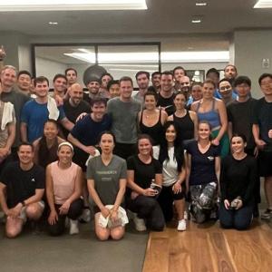 A group posed in a gym