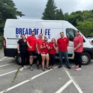 Bread of Life van and KeyBank volunteers shown.