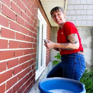 KeyBank volunteer shown cleaning windows.