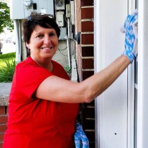 KeyBank volunteer washing windows.