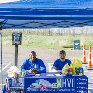 People seated at a booth "MHVI"