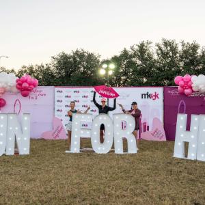Sign reading "RUN FOR HER"