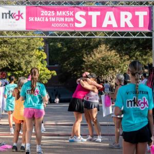Smiles and a warm embrace at the finish line of the 2025 MK5K where community spirit and generosity come together to make a lasting difference for women across the country. (Photo Courtesy: Paul Vela)
