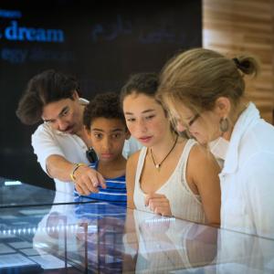 4 people looking at exhibit