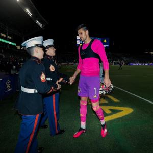 LA Galaxy's Johnathon Bond shakes hands with the Hero Of The Match Sergeant Rechelle Hoppers of the U.S. Marine Corps, who is of the Pride Community.