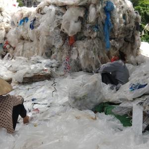Women removing bar codes and stickers by hand from clear film plastics imported from Europe at an informal recycling village outside of Hanoi, Vietnam. Source: Dr. Jenna Jambeck