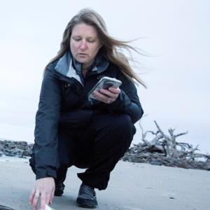 Dr. Jambeck picks up and logs litter with the mobile app Debris Tracker. Source: Dorothy Kozlowski, University of Georgia