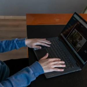 hands resting flat on the keyboard of a BlindLook laptop