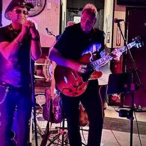 HARMAN employees playing an electric guitar and singing.