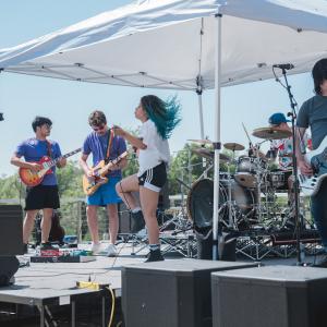 HARMAN employee band; female singer is jumping on the stage.