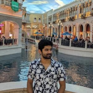 Manoj shown at a resort in Las Vegas with Venetian canals behind him.