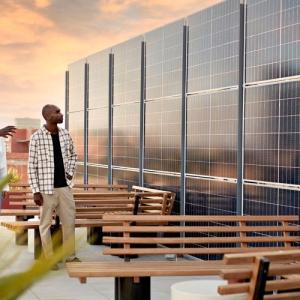 glass building with wooden benches on a patio