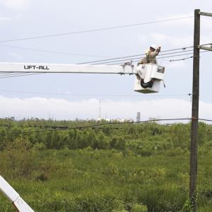 person working on utility pole